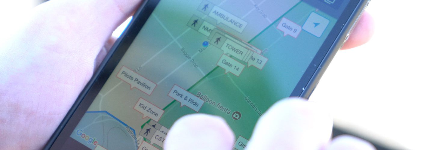 A responder uses a smartphone displaying a map of nearby locations and assets