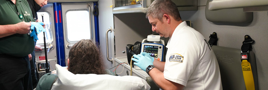 Emergency medical services personnel tend to a patient in an ambulance. Emergency medical services personnel tend to a patient in an ambulance.