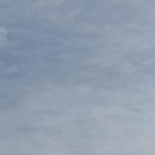 Cell tower against cloudy sky