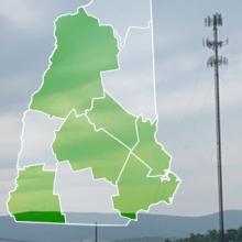 The state of New Hampshire, with outlined county borders; a cell tower.