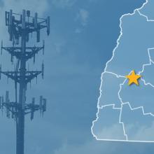 The State of New Hampshire, with outlined county borders and star locating Danbury, New Hampshire; a cell tower.
