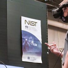 First responder using virtual reality head set inside the Public Safety Immersive Test Center with NIST and FirstNet Authority staff.